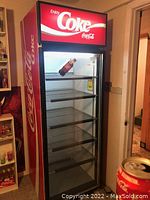 Full front view of cooler with door closed showing five wire shelves