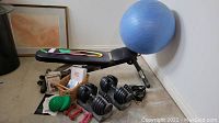 Overview of bench, exercise ball, Bowflex adjustable dumbbells, small dumbbells, resistance bands, balance pods and DVDs