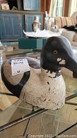 Side view of the antique duck decoy showing paint wear and detail.