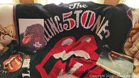 Wide view of the blanket, book, bag, and magazine showing the Rolling Stones 50th anniversary theme with iconic tongue logo and band branding.