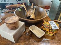 Overview of bowl, scoop, mallets, carved dish, olive wood lidded box, recipe tin