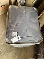 Clear view of the comforter set packaging in its sealed plastic container showing the item's condition and packaging state.