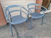 Two gray outdoor chairs side by side showing different angles, highlighting the overall design and condition, including damage on one chair's armrest.