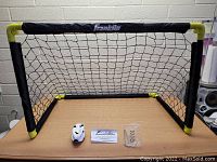 Fold-up kids soccer goal set including soccer goal with net, small ball, instruction manual, and accessory pack