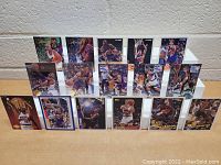 Front view of 15 Phoenix Suns basketball cards arranged on white display rack, featuring Charles Barkley, Kevin Johnson, Dan Majerle, Cedric Ceballos, and others in action and portrait shots.