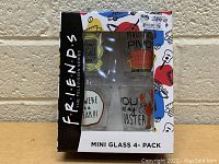 Boxed set of four mini glass shot glasses themed from Friends television series.
