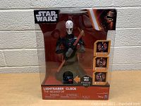 Front view of packaged Star Wars Lightsaber Clock The Inquisitor with try-me button visible.