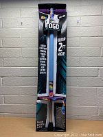 Front view of the Super Go Pogo Stick in its box showing branding, features and weight range.