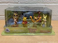 Front view of the sealed Winnie the Pooh figurine play set packaging showing all six character figurines