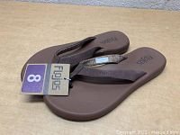 Photo showing new brown womens FloJos sandals with size 8 tag, single pair flat on surface