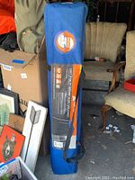 Blue carrying case of Ozark Trail Instant Slant Leg Canopy with label details