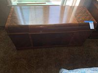 Closed view of vintage cedar chest showing wood grain lid and body