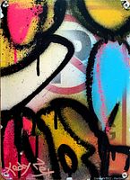 Close-up image showing vibrant abstract spray paint artwork with visible STOP sign background and artist signature.