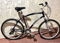 Full view of blue Diamondback Oak Point hybrid bike showing frame, seat, wheels, and handlebars