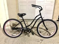 Full side view of the bicycle showing frame, wheels, saddle and kickstand