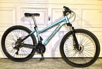 Full side profile view of the Schwinn AL COMP mountain bike showing its frame color, tires, and components.