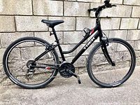Full side profile of bicycle against masonry wall