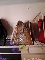 Side profile showing python print pattern, beige trim and handle