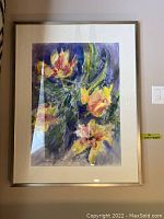 Full view of framed watercolor artwork showing abstract floral painting with yellow, orange, and green tones on a purple background.