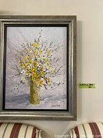 Front view of oil painting showing floral bouquet and frame