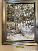Silver-tone framed oil painting by Jim Knighton depicting a snowy forest landscape.
