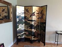 Front view of four-panel folding screen against wall