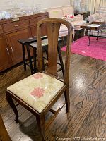 Oak guest chair front view showing carved splat back, cabriole front legs, floral upholstered seat