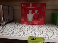 Photo of two Lampe Berger Paris perfume bottles on a floral patterned surface with box in background