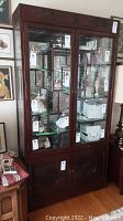 Front view of cabinet filled with porcelain figurines