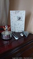 Full lot showing music box, pen, crystal paperweight, and white display case with Swarovski branding