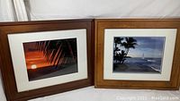 Both framed island-inspired photographs placed side by side, showing front view and frame condition