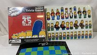 Sealed The Simpsons Fan Edition Trivia Game box and character chess pieces displayed in plastic mold with board.