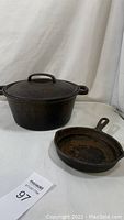 Photo showing both the cast iron Dutch oven with lid and the skillet on a white background.