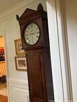 Front full view of tallcase clock in room