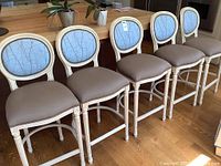 All five bar stools side by side showing matching frames and upholstery