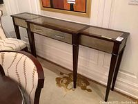 Front elevation showing entire table with three glass panels and center drawer pull