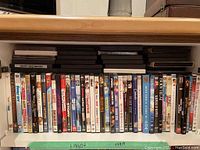 Shelves with assortment of DVDs, front facing showing titles