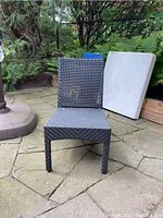 Single black wicker patio chair front view