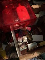 Cardboard tote with various boxed cologne sets and individual bottles including red CK One plastic case set and loose boxes