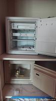 Open Sentry Safe showing interior shelves and keys attached to lock