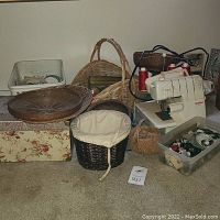 Photo showing the Bernina 2000 DE sewing machine surrounded by baskets, fabric pieces, and sewing accessories including buttons and thread spools.