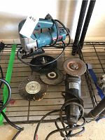 Photo showing Bosch jigsaw, Black & Decker grinder, and multiple grinding and wire brush attachments placed on a metal shelving unit.