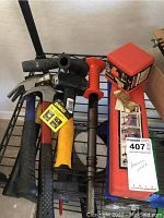Photo showing multiple hand hammers and Remington power hammer laid out with red boxed hammer accessories