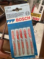 Close-up photo of unopened Bosch T118A jigsaw blades pack showing details and packaging.