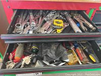 Top drawer with combination wrenches, Allen wrench sets, screwdriver bit sets and pliers, showing assortment of tools from Craftsman, Crescent and Pittsburgh brands.