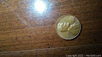 Photo of the 1968 Lincoln Wheat Penny with the profile of Abraham Lincoln and 'IN GOD WE TRUST' text visible.