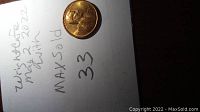 Photo of 1971 S mint mark Lincoln penny placed on white paper with handwritten notes indicating condition and year