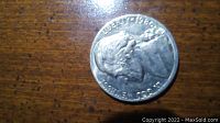 Close-up photo of a 1986 D mint nickel with worn features, faded Liberty and date run into the rim