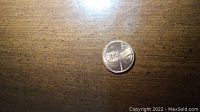 1992 D Lincoln penny placed on a wooden surface, front side visible with date and Lincoln portrait.