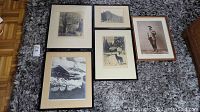 Five black and white framed photographs laid on carpet showing various scenes including a tree, building, dog, person, and mountain landscape.